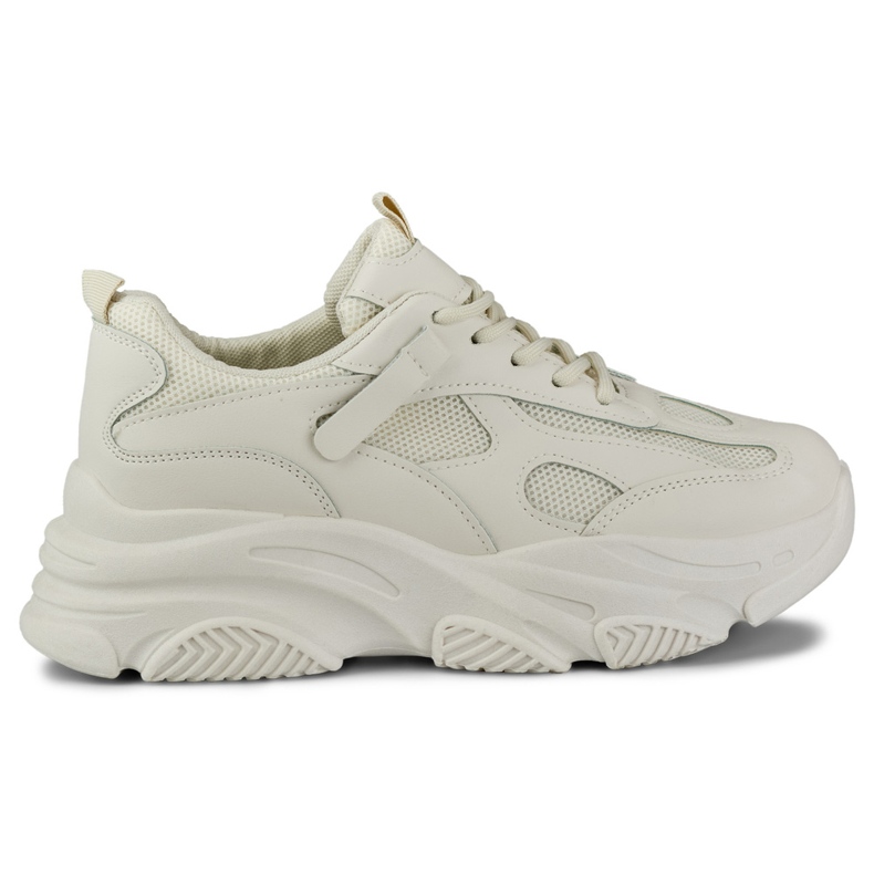 Naisten beigenväriset tennarit, joissa paksu pohja musta