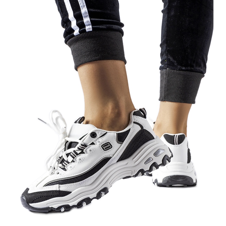 Kourin valkoiset ja mustat urheilulenkkarit valkoinen