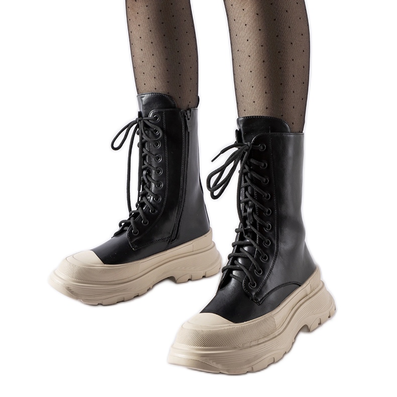 Mustat työläiskengät, joissa paksu beige Crosia-pohja