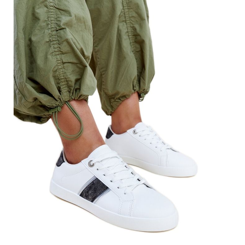 Valkoiset ja mustat tennarit, joissa koristeellinen Grada-raita valkoinen