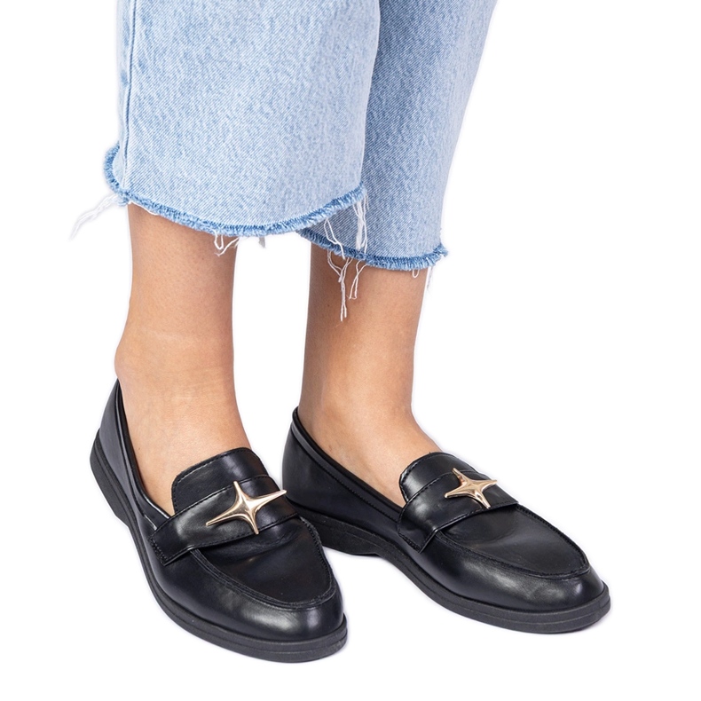 Mustat naisten housut kultakoristeilla