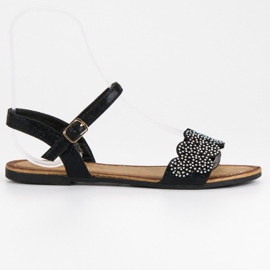 Comer Litteät sandaalit, jotka kiinnitetään soljella musta