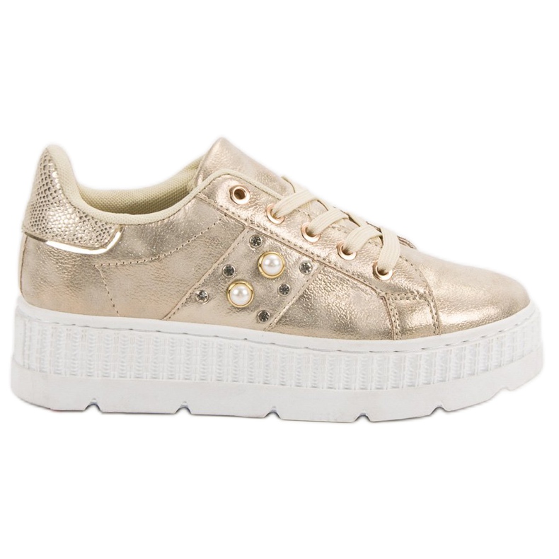 Kultaiset jalkineet alustalla kultainen