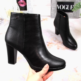 Mustat eristetyt naisten saappaat pylväässä. M. Daszyński 1